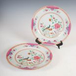 A pair of Chinese porcelain famille rose plates, Qing Dynasty, decorated in the double peacock