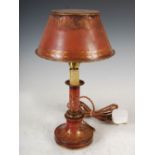A 19th century red ground Toleware table lamp and shade, decorated with gilded flowers and