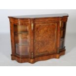 A Victorian walnut and gilt metal mounted credenza, the shaped top above a panelled cupboard door