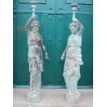 A pair of 20th century bronze figural torcheres, modelled as classical maidens holding aloft foliate