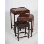 A nest of three Chinese dark wood occasional tables, Qing Dynasty, the rectangular panelled tops