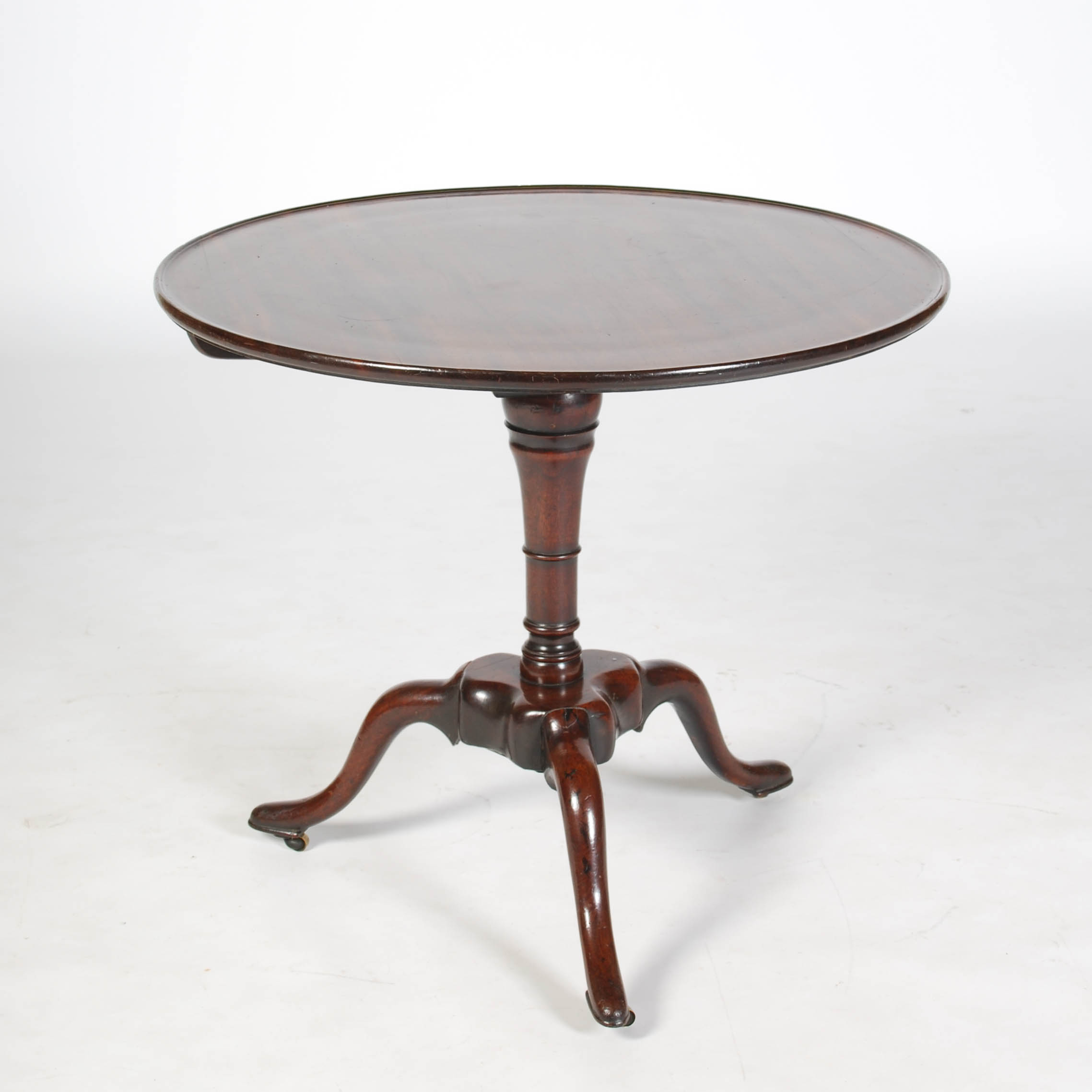 A George III mahogany bird cage tripod table, the hinged circular top with a slightly raised