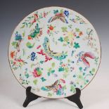 A Chinese porcelain famille rose celadon ground dish, Qing Dynasty, decorated with scattered foliate