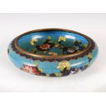 A Chinese blue ground cloisonne bowl, Qing Dynasty, decorated with peony and foliage on a trellis