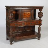 A 17th century style oak court cupboard, the rectangular top above a marquetry inlaid cupboard