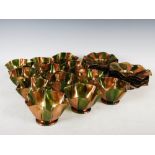 A set of twelve green and gilt Venetian glass finger bowls and saucers, with frilled rims, the