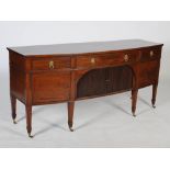 A George III style mahogany bow front sideboard, the shaped rectangular top above a long frieze