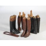 Five pairs of riding boots with original wood stretchers, three black pairs, two brown pairs,