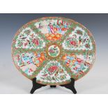 A Chinese porcelain famille rose Canton oval shaped meat plate, Qing Dynasty, decorated with