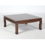 A Chinese dark wood square shaped low table, the panelled top raised on four square section supports