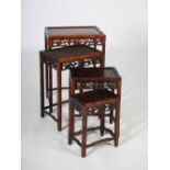A quartetto of Chinese dark wood occasional tables, Qing Dynasty, the rectangular panelled tops