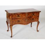 An 18th century Italian walnut, marquetry and ormolu mounted serpentine commode, the shaped