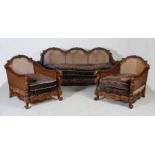 An Edwardian walnut three piece Bergere suite, comprising; three seat sofa and two armchairs, with