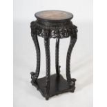 A Chinese dark wood jardiniere stand, Qing Dynasty, the circular top with mottled red marble insert,