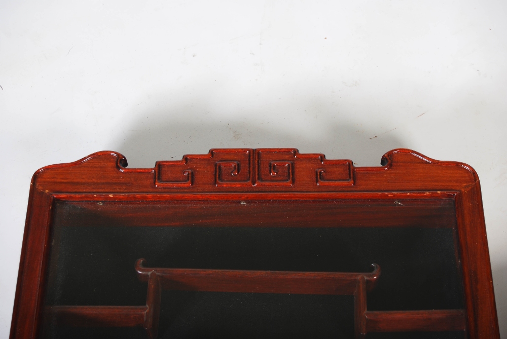 A pair of Chinese dark wood wall mounted display cabinets, the glazed cupboard doors opening to - Image 2 of 5