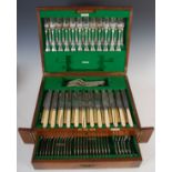 An early 20th century oak cased twelve place canteen of Kings pattern silver flatware and cutlery,