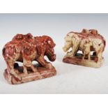 A pair of Chinese soapstone elephants, late Qing Dynasty, carved standing with pairs of attendant