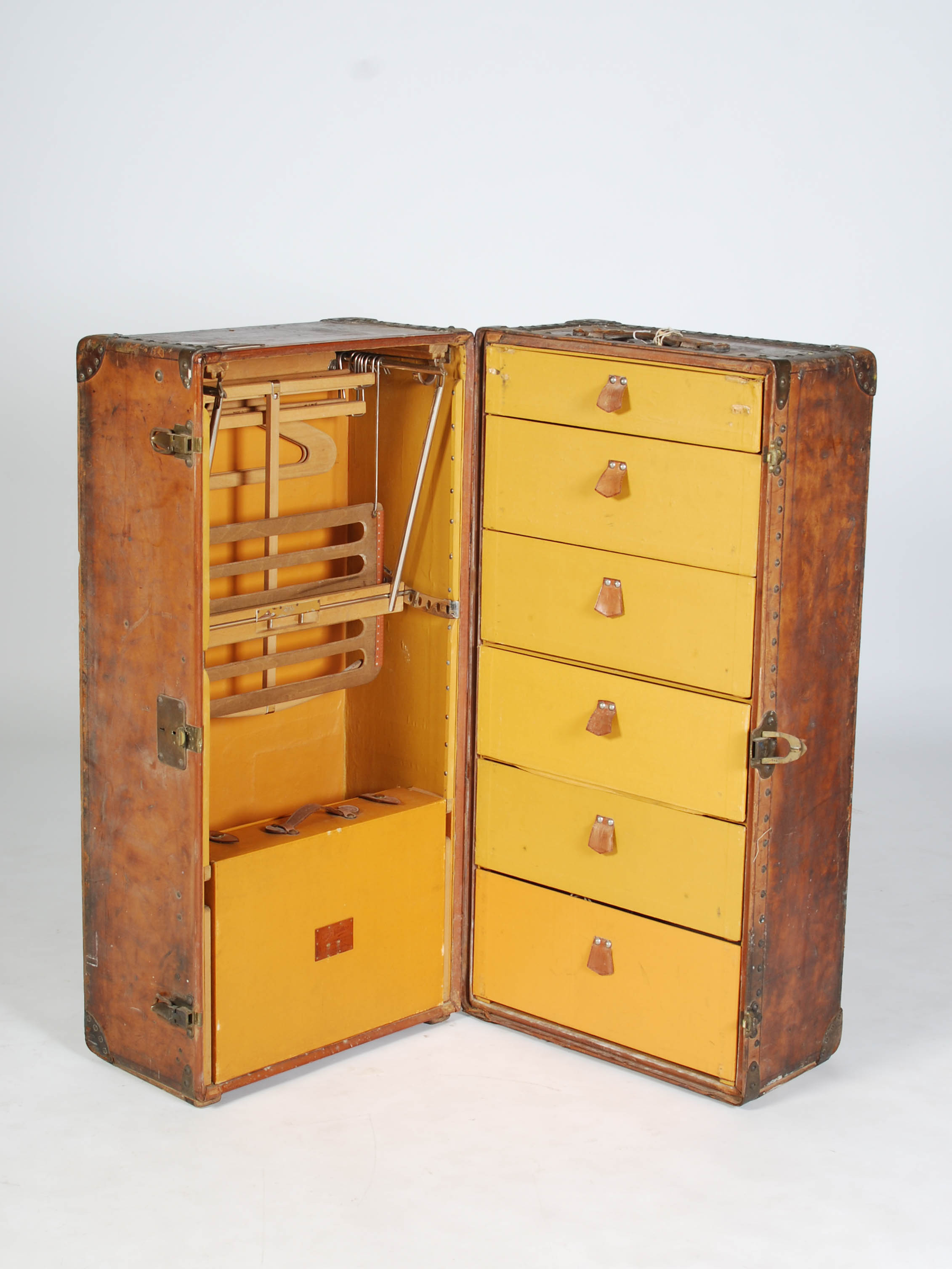 An early 20th century Louis Vuitton brown leather wardrobe trunk or malle armoire, opening to a