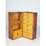 An early 20th century Louis Vuitton brown leather wardrobe trunk or malle armoire, opening to a