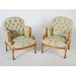 A pair of Edwardian mahogany and parcel gilt tub chairs, the button down upholstered backs, arms and