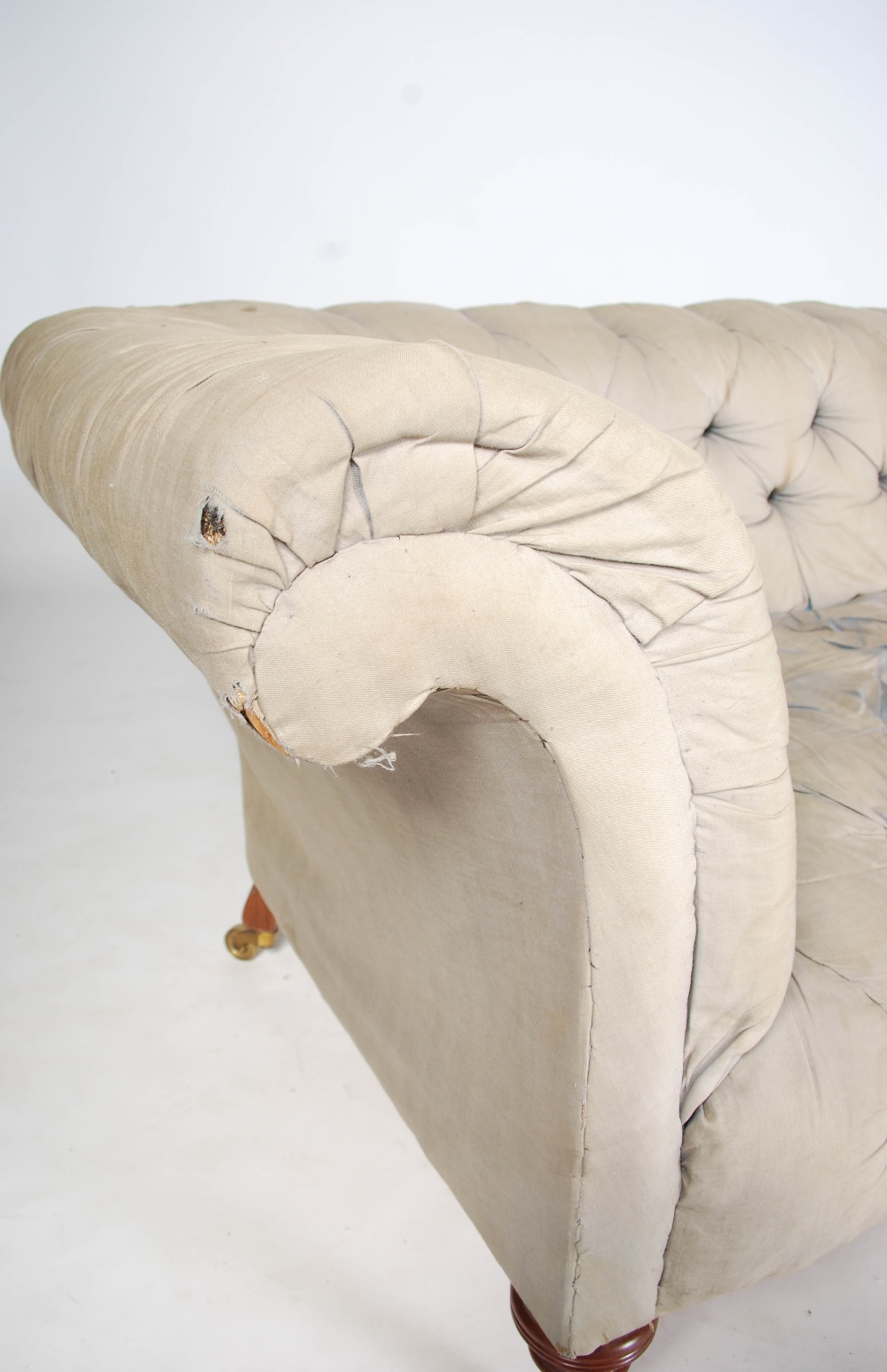 A Howard & Sons walnut Chesterfield sofa, raised on turned supports with brass cups and castors, - Image 2 of 6