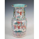 A Chinese porcelain famille rose Canton vase, Qing Dynasty, decorated with panels of figures on a