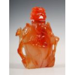 A Chinese carnelian snuff bottle and stopper, carved in relief with peony and birds, 8cm high