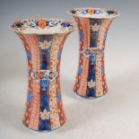 A pair of Japanese Imari vases, late 19th/early 20th century, of reeded form decorated with fan