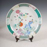 A Chinese porcelain famille rose dish, late Qing Dynasty, decorated with rockwork issuing
