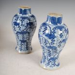 A pair of Chinese porcelain blue and white jars, Qing Dynasty, decorated with foliage and trailing