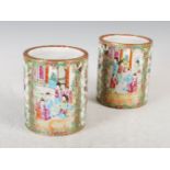 A pair of Chinese porcelain famille rose Canton brush pots, Qing Dynasty, decorated with panels of