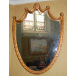 A decorative shield shaped wall mirror in the Neo Classical style, 93cm high x 69cm wide