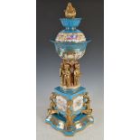 A Continental porcelain blue celeste ground table centrepiece, decorated with panels of putti and