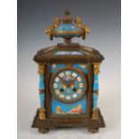 A late 19th century gilt metal and porcelain mounted mantel clock, the circular dial with Roman