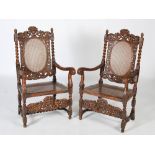 A pair of late 19th century Carolean style carved walnut armchairs, the top rails carved and pierced