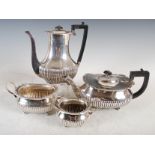 A Victorian silver four piece tea set, London 1886, makers mark of Edward Hutton, oval shaped with