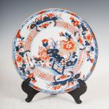 A pair of Chinese porcelain Imari plates, Qing Dynasty, decorated with fenced gardens of rockwork