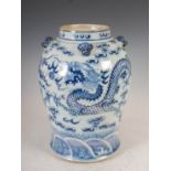 A Chinese porcelain blue and white jar, Qing Dynasty, decorated with a pair of dragons contesting