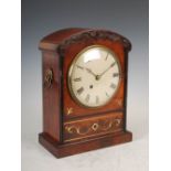 A 19th century Regency mahogany and brass inlaid mantel clock, the 6" enamelled dial with Roman