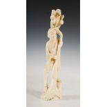 A Japanese ivory okimono of a man and monkey, Meiji Period, 19.5cm high