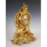 A late 19th century ormolu Rococo style mantel clock, Journeux a Paris, the circular dial with