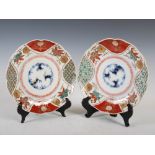 A pair of Imari plates, late 19th/early 20th century, the central roundels decorated with bamboo,
