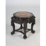 A Chinese dark wood jardiniere stand, Qing Dynasty, the shaped circular top with mottled red