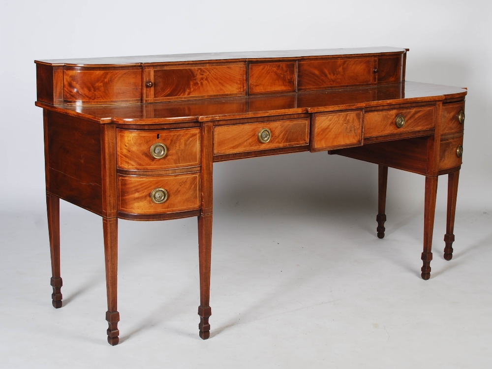 A Scottish George III mahogany and boxwood lined sideboard, the stage back with two sliding doors on