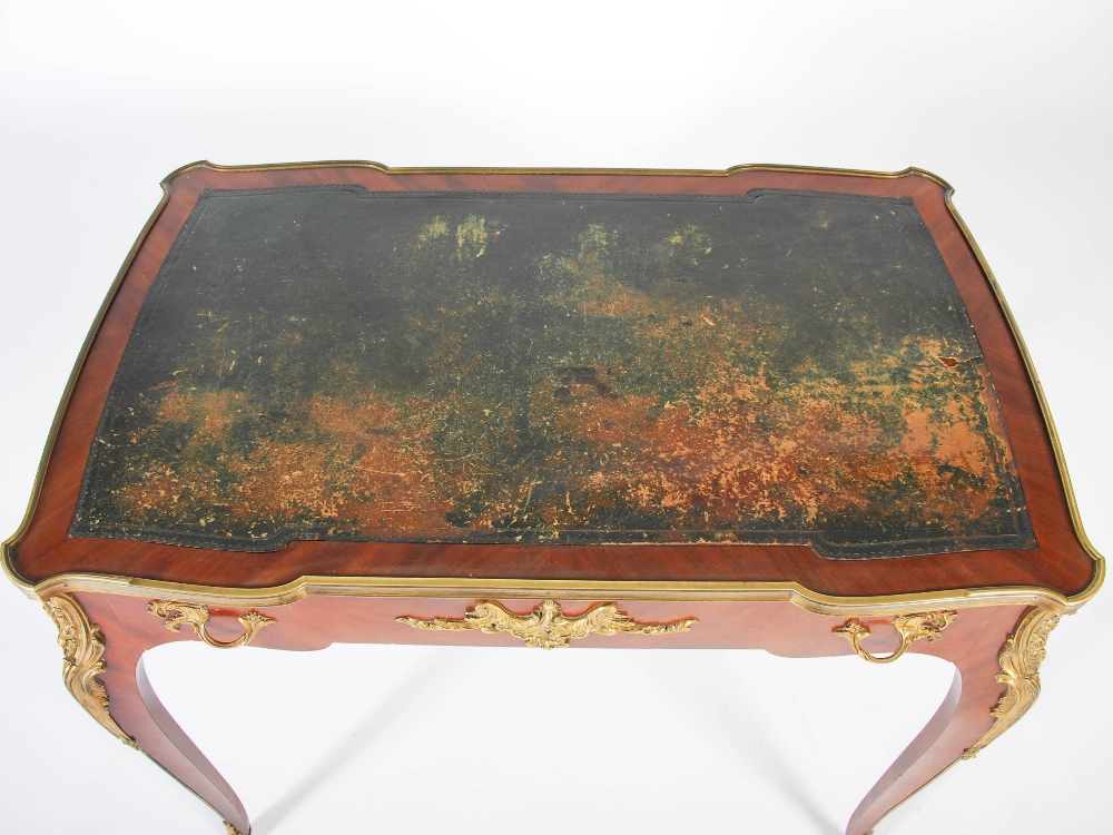 A late 19th/early 20th century mahogany and gilt metal mounted writing table in the Louis XV style - Image 3 of 6