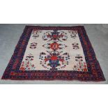 A white ground Afshar rug, early 20th century, the rectangular field centred with a large flower