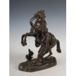After Guillaume Coustou, a bronze marley horse and attendant, signed in the bronze, 28cm high.