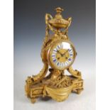 A late 19th century French ormolu mantel clock in the Louis XV style, the circular dial set with
