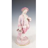 A late 19th century Continental Bisque porcelain figure of a young gentleman, modelled standing