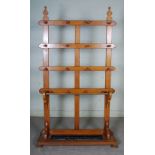 A Victorian oak hall stand, with open frame back and twelve coat pegs, with brass fronted